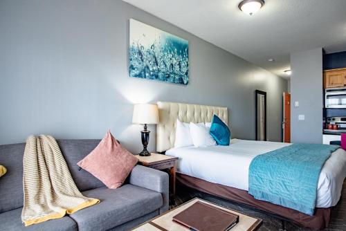 a bedroom with a bed and a couch at Inn at the Prom Oceanfront in Seaside