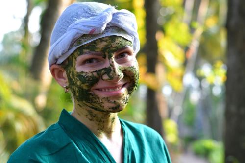 a man with his face covered in mud at Soma Manaltheeram Ayurveda BeachVillage in Kovalam
