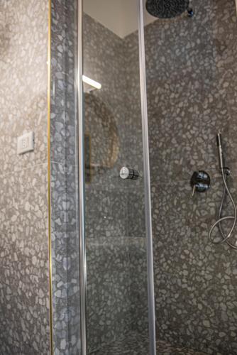 a shower with a glass door in a bathroom at U'Panare in Taranto