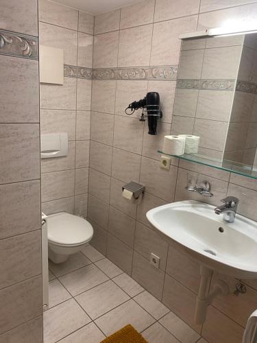 a bathroom with a sink and a toilet at Gasthaus Rössle in Nenzing
