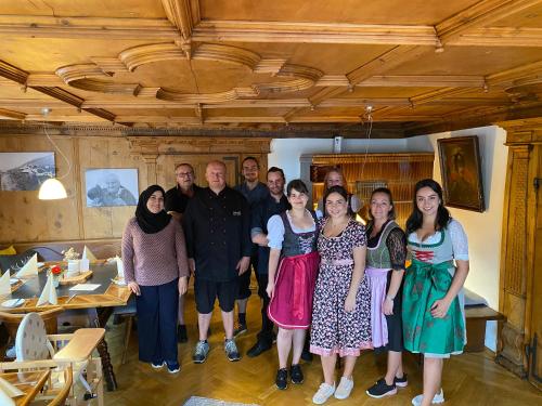 a group of people posing for a picture in a room at Gasthaus Rössle in Nenzing