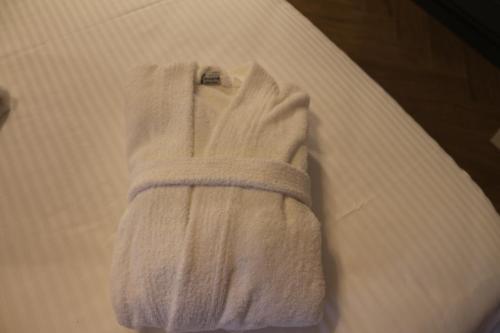 a towel is draped over the side of a bed at FILEO ELEGANT LIVING in Veria