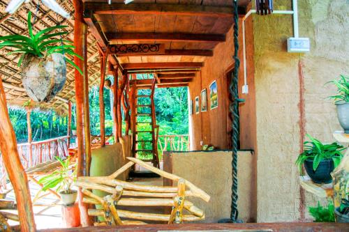 a porch with a couple of chairs on a patio at Relax Nature Villa in Sigiriya