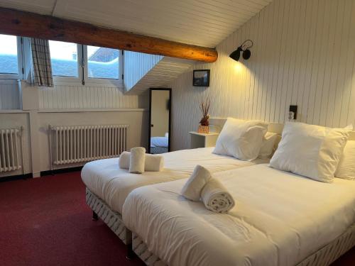 a bedroom with two beds with white sheets and pillows at Relais Des Villards in Séez