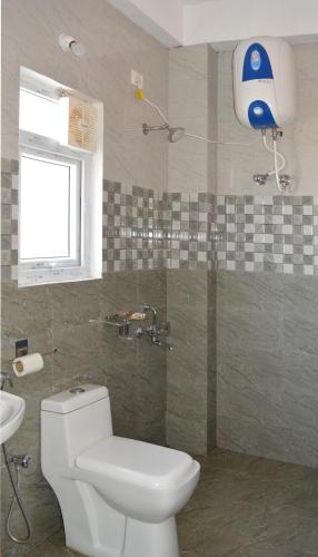a bathroom with a white toilet and a sink at EDEN Paradisee in Ooty