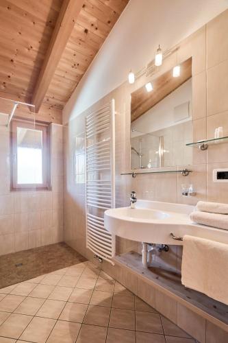 a bathroom with a sink and a mirror at Residence Schiestlhof in Natz-Schabs
