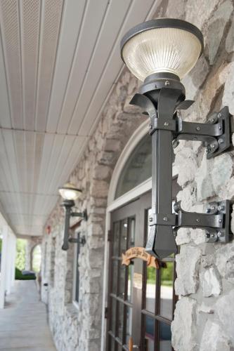 a light on the side of a stone building at The Stone Castle Hotel & Conference Center in Branson