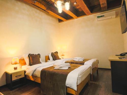 Ένα ή περισσότερα κρεβάτια σε δωμάτιο στο Rayyan Hotel Bukhara
