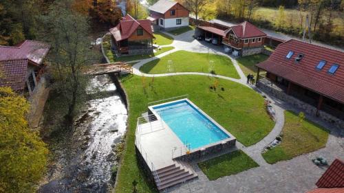 an aerial view of a house with a swimming pool at Darino in Rodnikovka