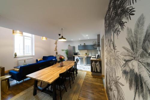 comedor y sala de estar con mesa de madera en AppartUnique - Chez Helder en Vichy