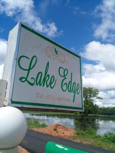 a large sign for a lake college on the side of a road at lake Edge Dambulla in Dambulla