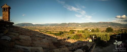 a view of a city from a stone wall at Agriturismo Casa Orsini in Montefalco