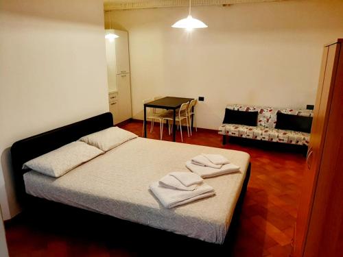 a bedroom with a bed with two towels on it at Il vicolo By Turistica in Domodossola