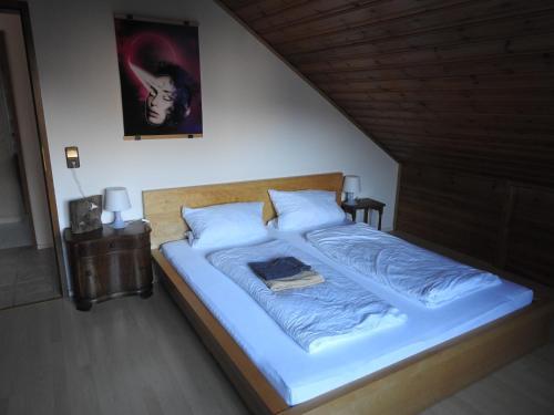 a bedroom with a bed with blue blankets and pillows at Ferienwohnung Narziss in Bad Kissingen