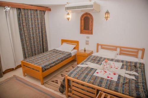 מיטה או מיטות בחדר ב-Lagona Dahab Hotel