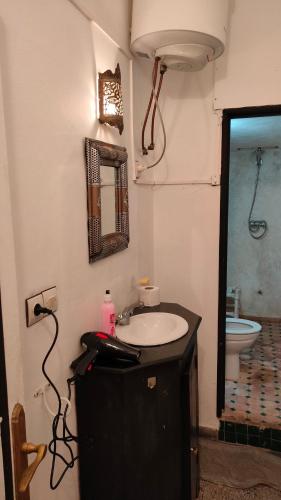 a bathroom with a sink and a mirror at Samad apartments in Essaouira