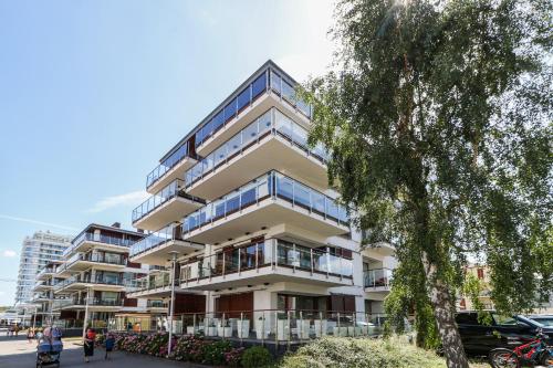 ein Apartmenthaus mit Balkon auf einer Straße in der Unterkunft Baltic Park Plaza by Baltic Home in Świnoujście