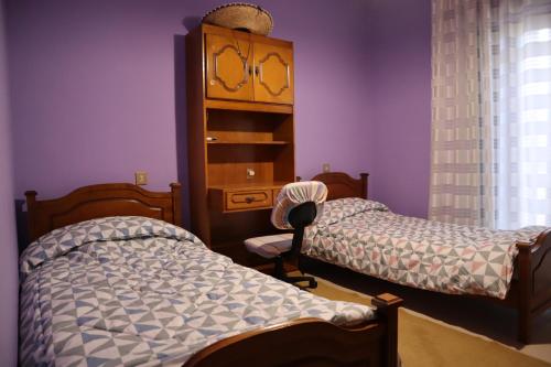 a bedroom with two twin beds and a dresser at Fofi's Place in Magoulítsa