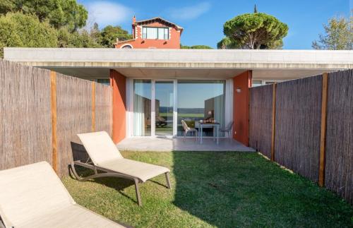a small backyard with two chairs and a fence at Mas Ses Vinyes - Adults Only in Begur