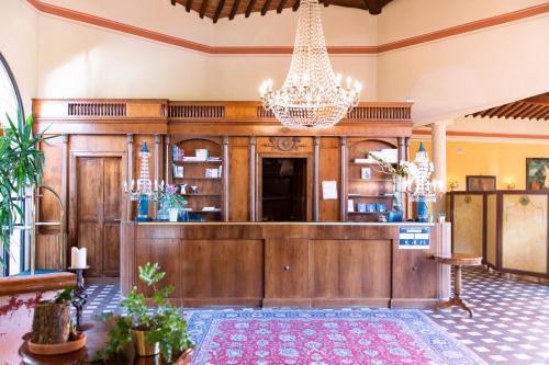 a large kitchen with a chandelier at Il Piccolo Castello in Monteriggioni