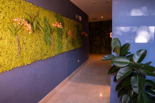a hallway with a wall with flowers on it at Il Piccolo Castello in Monteriggioni