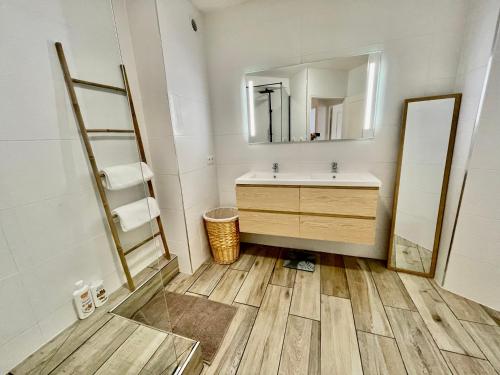 a bathroom with a sink and a mirror at Nouveauté - L'Oasis - T3 - 70 M2 - Jacuzzi in Saint-Denis