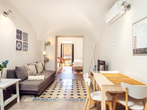 a living room with a couch and a table at Apartamentos Plaza Mayor 35 in Cáceres