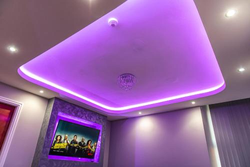 a purple ceiling in a room with a tv at Meridian Serviced Apartments in Bradford