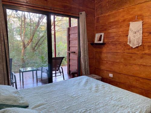 a bedroom with a bed and a sliding glass door at Casa Rustica in Brasilito