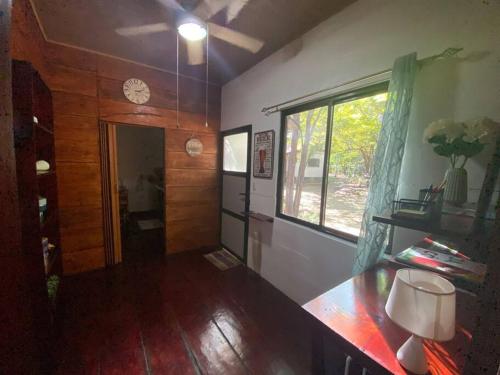 a living room with a table and a window at Casa Natural Madera in Brasilito
