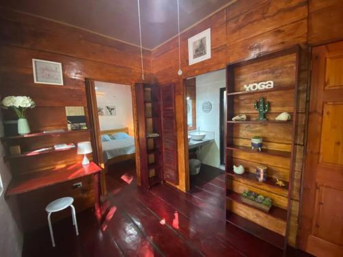 a room with a bedroom with a desk and a mirror at Casa Natural Madera in Brasilito