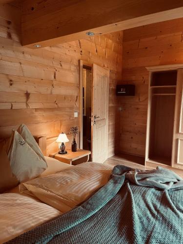 a bedroom with a bed in a log cabin at Herbst Alm in Unken