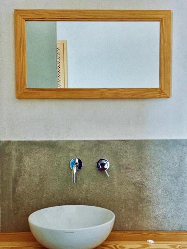 a bathroom sink with a mirror and a white bowl at Lavinum in Monte di Procida