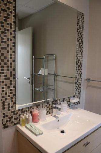 a bathroom with a sink and a large mirror at Smart Living Villa in Dubai