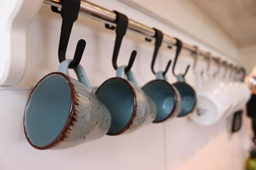 a row of pots and pans hanging on a wall at Pod Beskydem, Velké Karlovice in Velké Karlovice