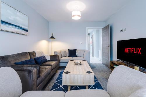 a living room with a couch and a tv at Cestrian House in Chester