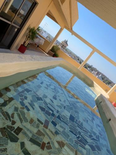 a swimming pool with a tile floor in a house at Hotel Los Angeles in Gualeguaychú