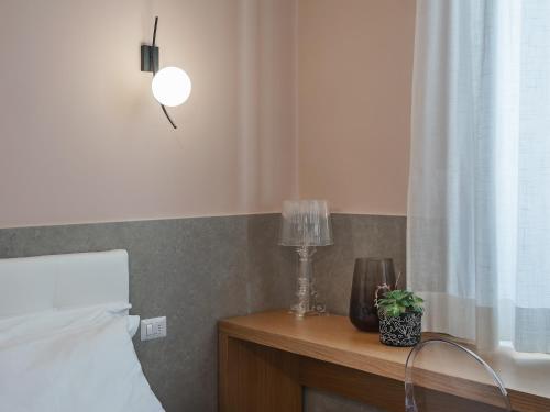 a bedroom with a bed and a table with a lamp at Maison boutique Matteotti in Matera