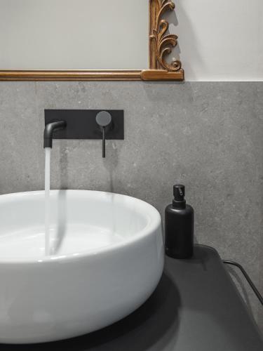 a white sink with a faucet on a counter at Maison boutique Matteotti in Matera