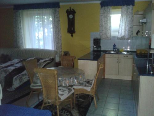 a kitchen with a table and chairs in a room at Elefánt Apartment in Keszthely