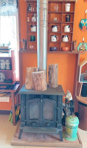 a stove in a room with a shelf of dishes at 熊居民宿Lala Mountain Bear Farm in Hualing