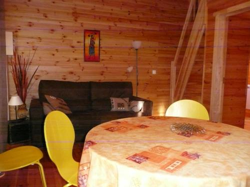 a room with a table and chairs and a couch at Les gîtes des Palombes in Fronton