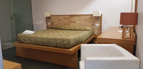a bedroom with a bed and a bath tub at Dal Patricano in Frosinone