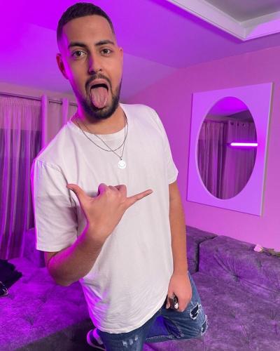 a man is standing in a purple room at Tsarevets Boutique Hotel & SPA in Veliko Tŭrnovo