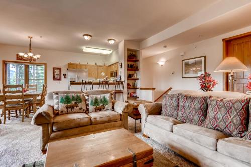 a living room with two couches and a table at Los Pinos - Luxury Breckenridge SkiCondo in Breckenridge