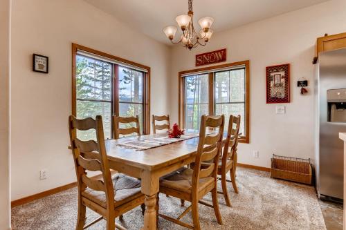 a dining room with a wooden table and chairs at Los Pinos - Luxury Breckenridge SkiCondo in Breckenridge