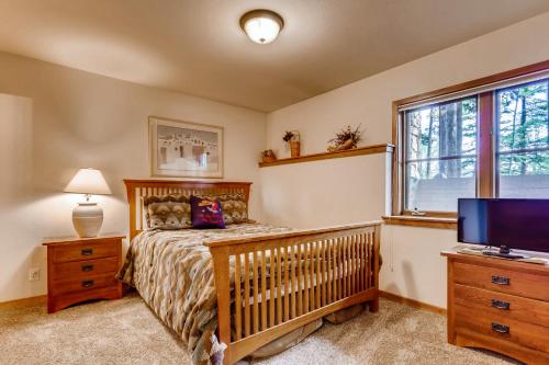 a bedroom with a crib and a flat screen tv at Los Pinos - Luxury Breckenridge SkiCondo in Breckenridge