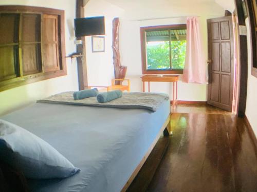 a large bed in a room with a window at Moon River Resort Phimai in Pi Mai