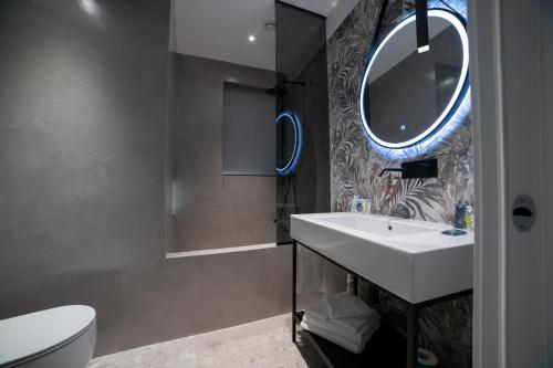 a bathroom with a sink and a mirror at Marconi Hotel in Rende