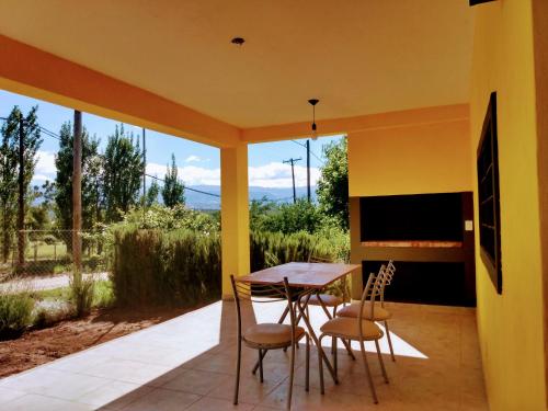 a dining room with a table and chairs on a patio at Cabañas Y Departamentos Bettylu in Villa Cura Brochero